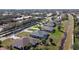 An aerial photo captures the backyard, highlighting the screened-in pool, lanai, and surrounding green lawn at 2115 Pan American Blvd, North Port, FL 34287