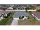 Aerial view of single-Gathering home showcasing the roof, landscaping, and neighborhood at 2115 Pan American Blvd, North Port, FL 34287