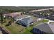 An aerial perspective reveals the property's backyard, screened-in pool, and a lush green lawn at 2115 Pan American Blvd, North Port, FL 34287