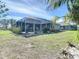 The backyard features a screened lanai with well-maintained landscaping with room for outdoor seating at 2115 Pan American Blvd, North Port, FL 34287