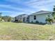 Spacious backyard featuring lush greenery and a screened-in lanai at 2115 Pan American Blvd, North Port, FL 34287