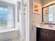 Stylish bathroom featuring a walk-in shower, soaking tub, and a modern vanity with framed artwork at 2115 Pan American Blvd, North Port, FL 34287