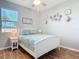 Well-lit bedroom with beachy décor, a large window, and light walls at 2115 Pan American Blvd, North Port, FL 34287