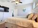 Comfortable bedroom with a bed that has built-in storage and a mounted TV at 2115 Pan American Blvd, North Port, FL 34287