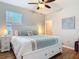 Bright bedroom featuring a large bed, coastal decor, and a window letting in natural light at 2115 Pan American Blvd, North Port, FL 34287