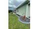 Home exterior with a screen enclosed lanai and well manicured lawn at 2115 Pan American Blvd, North Port, FL 34287