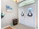 Bright foyer featuring double doors, transom window, neutral walls, and tile flooring at 2115 Pan American Blvd, North Port, FL 34287