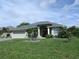 Charming one-story home featuring a two-car garage and well-manicured landscaping at 2115 Pan American Blvd, North Port, FL 34287