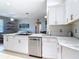 Bright kitchen features white cabinetry, stainless steel appliances, granite countertops and an open layout for seamless entertaining at 2115 Pan American Blvd, North Port, FL 34287