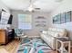 Cozy living room with stylish decor, a comfortable sofa, and a window for natural light, creating a relaxing atmosphere at 2115 Pan American Blvd, North Port, FL 34287