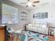 Bright living room with light grey walls, modern decor, and plush white seating area on top of a cool toned rug at 2115 Pan American Blvd, North Port, FL 34287