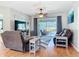 Comfortable living room with stylish decor, ceiling fan, and patio access through sliding doors at 2115 Pan American Blvd, North Port, FL 34287