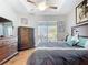Spacious primary bedroom boasts hardwood floors, tray ceiling, with sliding door access to the lanai at 2115 Pan American Blvd, North Port, FL 34287