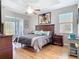 Spacious primary bedroom boasts hardwood floors, tray ceiling, with sliding door access to the lanai at 2115 Pan American Blvd, North Port, FL 34287