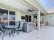 Inviting patio boasts a hot tub, outdoor seating, and a ceiling fan, perfect for relaxation at 2115 Pan American Blvd, North Port, FL 34287