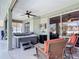 Relaxing outdoor patio features a hot tub, comfortable seating, and a ceiling fan for comfort at 2115 Pan American Blvd, North Port, FL 34287