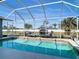Screened-in pool area includes a clear view, lounge chairs, and lovely backyard landscaping at 2115 Pan American Blvd, North Port, FL 34287