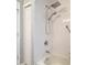 Modern shower with white tiles, a handheld shower head, and grab bars at 2115 Pan American Blvd, North Port, FL 34287
