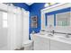 Stylish bathroom boasts bright blue walls, a modern vanity, and well-placed lighting fixtures at 213 Venice Palms Blvd, Venice, FL 34292