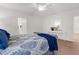 Bedroom features modern furniture, a large ceiling fan, and an ensuite bath at 213 Venice Palms Blvd, Venice, FL 34292