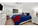 Bright bedroom with a large window, ceiling fan, and comfortable furnishings create a welcoming atmosphere at 213 Venice Palms Blvd, Venice, FL 34292