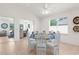 Dining area features vaulted ceiling, tile flooring, bright lighting, and table set for six guests at 213 Venice Palms Blvd, Venice, FL 34292