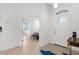 Entryway with tiled floors and a view into the brightly lit bedroom, and the home's front door at 213 Venice Palms Blvd, Venice, FL 34292