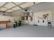 Spacious garage with organized storage, a utility sink, and room for two scooters at 213 Venice Palms Blvd, Venice, FL 34292