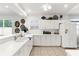 All-white kitchen featuring ample cabinetry, countertops, modern appliances, and natural lighting, perfect for cooking and entertaining at 213 Venice Palms Blvd, Venice, FL 34292