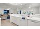 Bright kitchen featuring white cabinetry, ample counter space, modern appliances and an open view to the dining and living areas at 213 Venice Palms Blvd, Venice, FL 34292