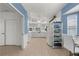 Spacious kitchen featuring white cabinetry, modern appliances, neutral tile floors and high vaulted ceilings at 213 Venice Palms Blvd, Venice, FL 34292