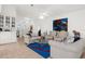 Inviting living room featuring comfortable seating, tiled flooring, accent rug, and bright natural light, creating a welcoming ambiance at 213 Venice Palms Blvd, Venice, FL 34292