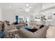 Spacious open-concept living and dining area featuring stylish furnishings, tiled flooring, and bright natural light throughout at 213 Venice Palms Blvd, Venice, FL 34292