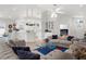 Open-concept living room with neutral color palette, tile floors, and comfortable seating, creating a welcoming and bright space at 213 Venice Palms Blvd, Venice, FL 34292