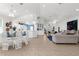 Open-concept floorplan with living, dining, and kitchen featuring neutral tones, tile floors, and plenty of natural light at 213 Venice Palms Blvd, Venice, FL 34292