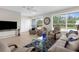 Living room showcasing tile flooring, comfortable seating, large windows, and bright, natural light at 213 Venice Palms Blvd, Venice, FL 34292
