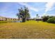 Lush backyard showcasing a serene water view, mature trees, and green space in a tranquil community setting at 2221 Bal Harbour Dr, Venice, FL 34293