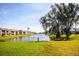 Picturesque backyard featuring a tranquil canal view, lush greenery, and a serene waterside setting at 2221 Bal Harbour Dr, Venice, FL 34293