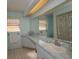 This bathroom features a vanity with a large mirror and a shower/tub at 2221 Bal Harbour Dr, Venice, FL 34293
