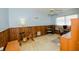 This bedroom has a ceiling fan, wood paneling, and a stationary exercise bike at 2221 Bal Harbour Dr, Venice, FL 34293