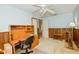 This bedroom has a ceiling fan, a desk, and a stationary exercise bike at 2221 Bal Harbour Dr, Venice, FL 34293