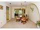 Cozy dining area featuring a glass table, wicker chairs, and decorative wall accents at 2221 Bal Harbour Dr, Venice, FL 34293