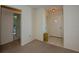 Hallway with neutral carpet, white walls, and a glimpse into the adjacent bathroom at 2221 Bal Harbour Dr, Venice, FL 34293