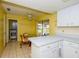 Bright kitchen featuring white cabinets, tile flooring, and a cozy breakfast nook with scenic views at 2221 Bal Harbour Dr, Venice, FL 34293