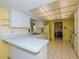 Kitchen with white cabinetry and appliances complemented by tile flooring, and an open layout at 2221 Bal Harbour Dr, Venice, FL 34293