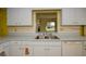 Well-lit kitchen sink features stainless steel fixtures, ample counter space, and functional design at 2221 Bal Harbour Dr, Venice, FL 34293