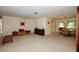 Spacious living room with carpet flooring and an adjacent dining area, perfect for entertaining at 2221 Bal Harbour Dr, Venice, FL 34293