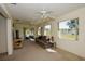 Inviting living room with a comfortable sofa, neutral carpet, and serene views of the lake at 2221 Bal Harbour Dr, Venice, FL 34293