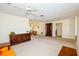 Open-concept living room with ample space, neutral carpet, and an adjacent dining area at 2221 Bal Harbour Dr, Venice, FL 34293