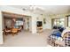 Open-concept living room with neutral carpet, comfortable seating, and seamless flow to the kitchen at 2221 Bal Harbour Dr, Venice, FL 34293